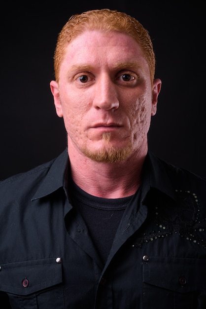 Close up of muscular man from Syria with orange hair isolated