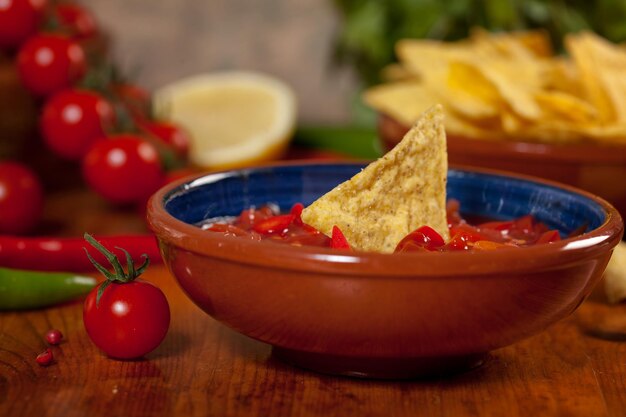 Photo close-up of nachos with sauce on table