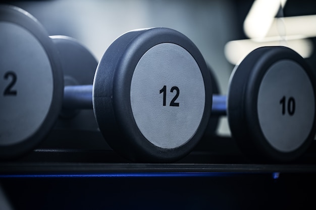 Close up of new dumbbells on a rack in a gym