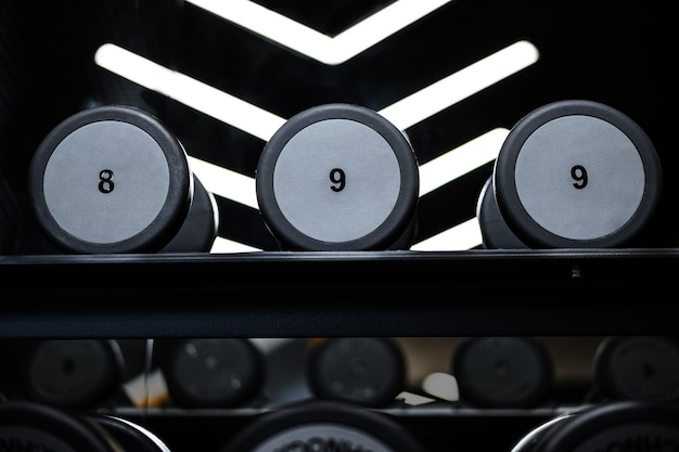 Close up of new dumbbells on a rack in a gym