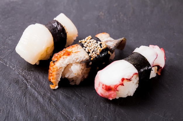 Close-up of nigiri sushi set on a black slate background