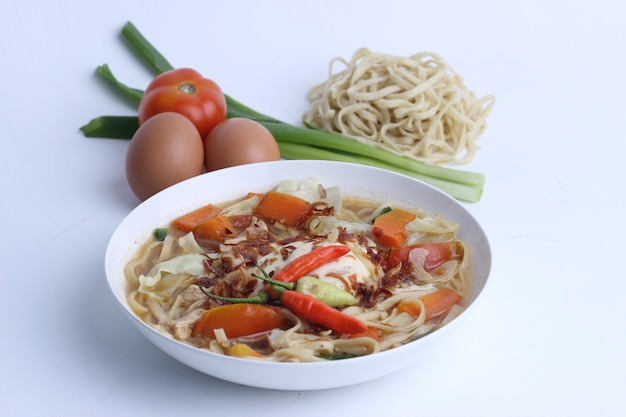 Close up on noodle soup with vegetables