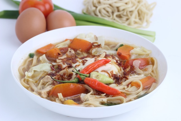 Close up on noodle soup with vegetables