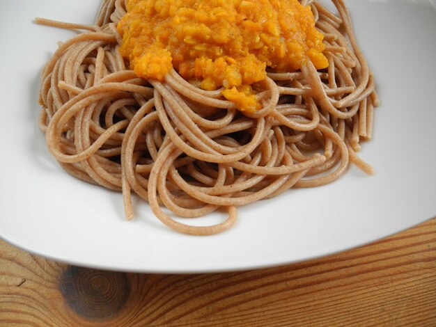 Close-up of noodles with gravy in plate on table