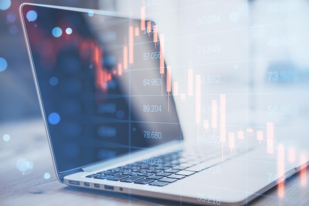 Close up of notebook with abstract falling candlestick forex chart on blurry background Crisis workplace and stock concept Double exposure