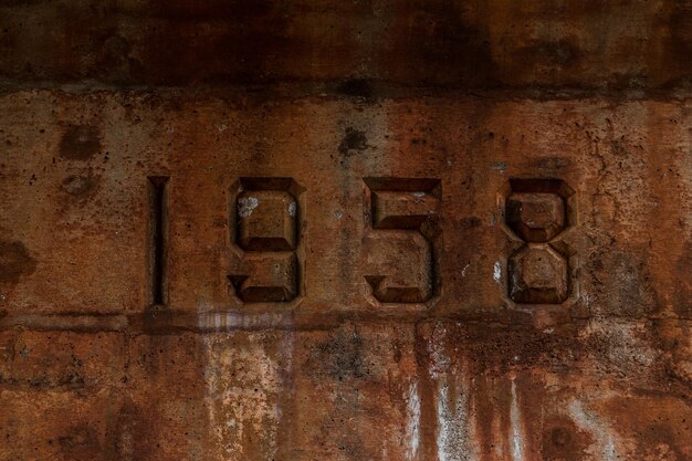 Close-up of number 1958 on old concrete wall