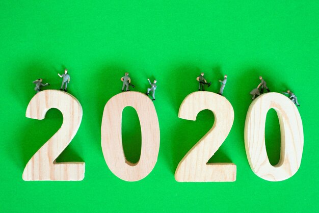 Photo close-up of number 2020 with toys on green background