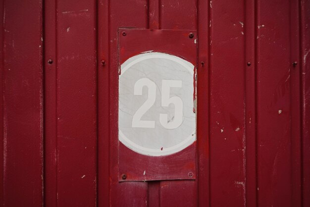 Close-up of number 25 on red wall