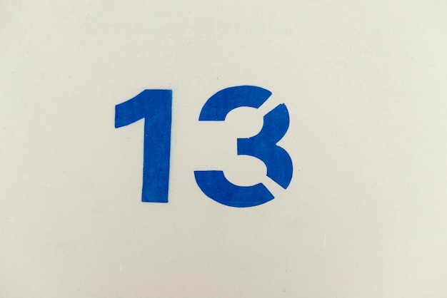 Photo close-up of number on white wall