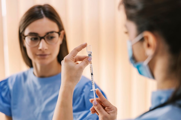 Close up of nurse preparing shot of insulin for a patient in hospital