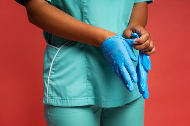Photo close up on nurse putting gloves on