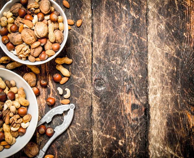 Close up on nuts in bowl with nutcracker