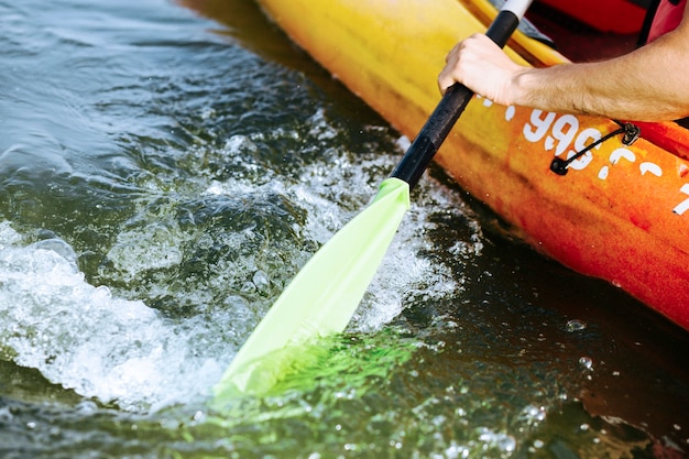 Close-up of oar paddle moving water