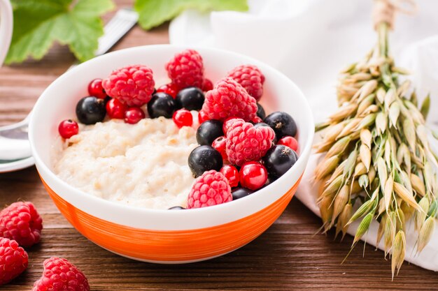 Close-up of oatmeal porridge and fresh berries in a bowl