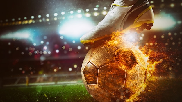 Фото Крупный план нападающего футбола, готового пнуть огненный мяч на стадионе