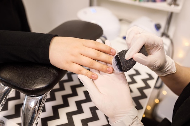 Фото Маникюрша крупным планом заботится о ногтях клиента, выполняя косметическую процедуру
