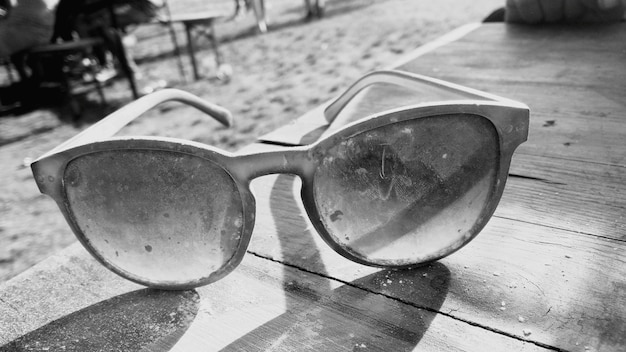 Фото Клоуз-ап старых солнцезащитных очков на столе на пляже