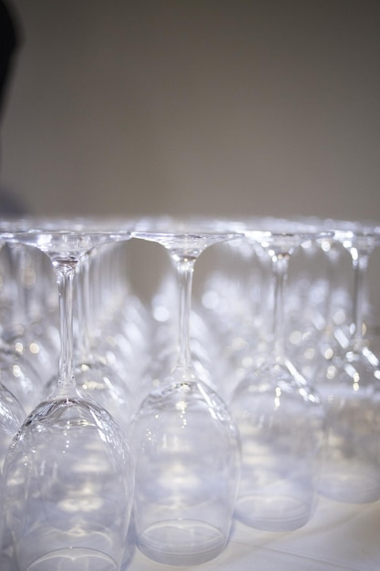 写真 灰色の背景に置かれたテーブル上の逆のワイングラスのクローズアップ