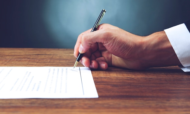 Close up of office worker filling documents