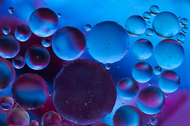 Close-up of oil bubbles in blue water