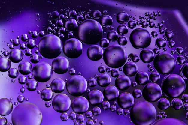 Close-up of oil bubbles in purple water
