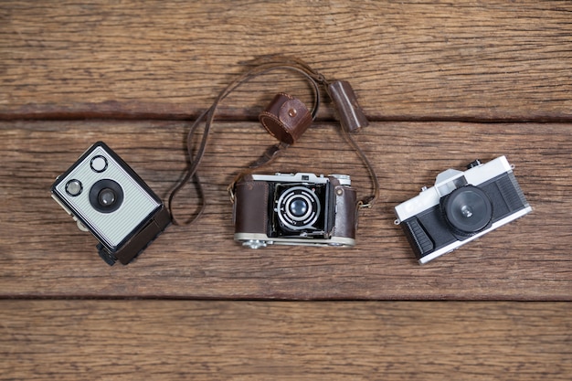 Close-up of old fashioned cameras on table