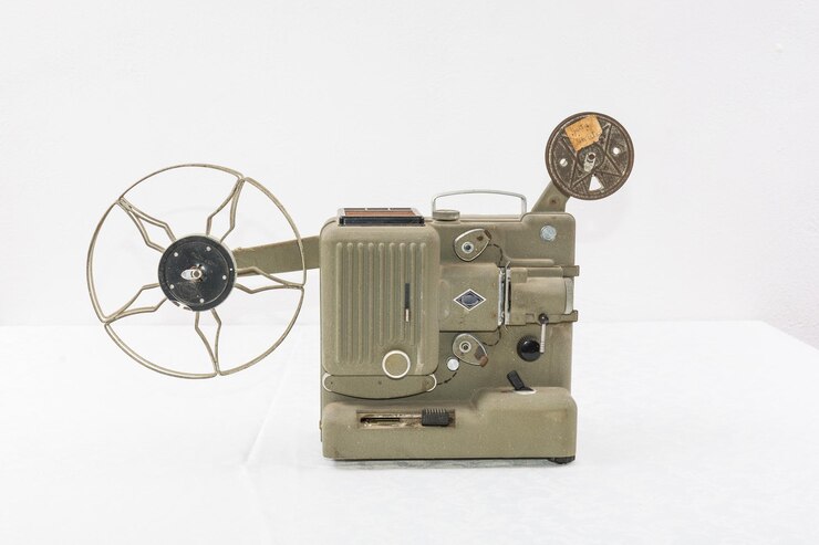 Photo close-up of old film projector against white background