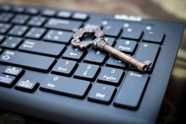 Close up old key and push-button the computer keyboard, data
protection by key concept