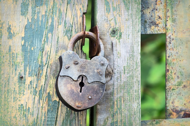 Close up on old lock on the fence