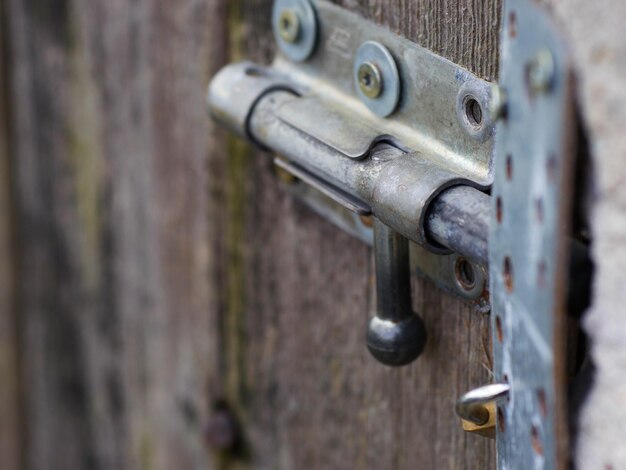 Photo close-up of old metal latch on door