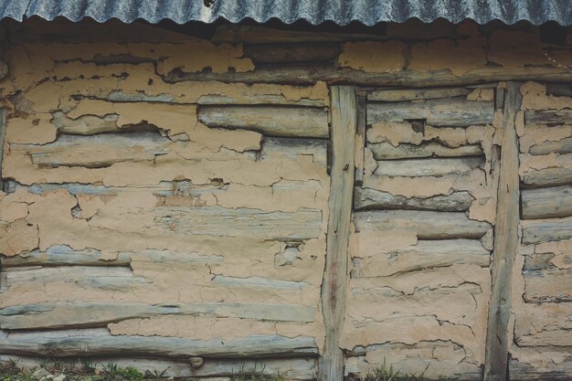 Close up old plastered log building concept photo