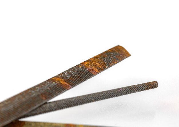 Close-up of old and rusty rasp tool equipment on a white background