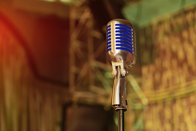 Close up of old style microphone technology. Metallic retro style karaoke equipment.