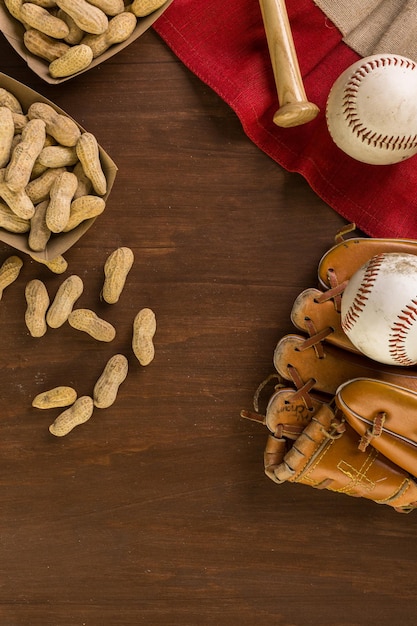 Close up of old worn baseball equipment on a wooden background.