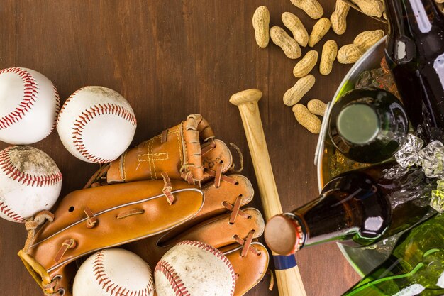 Close up of old worn baseball equipment on a wooden background.