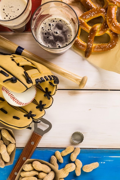 Close up of old worn baseball equipment on a wooden background.