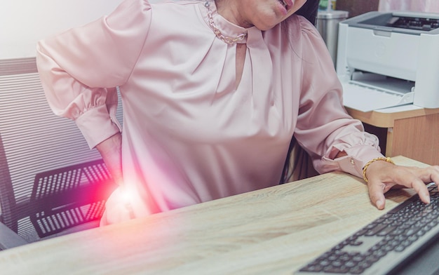 Close up older woman suffering from backpain health problem and people concept