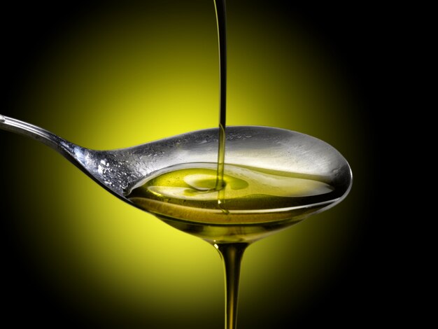 close up of olive oil poured into a spoon