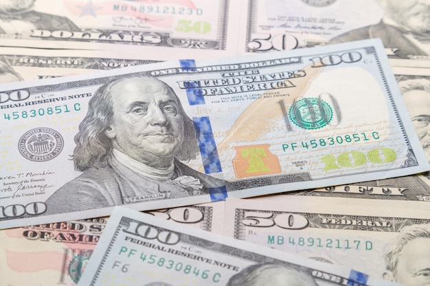 Close-up of one hundred and fifty dollar bills on the table.