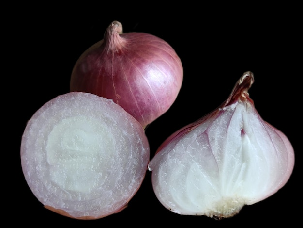 A close up of onions on a black background