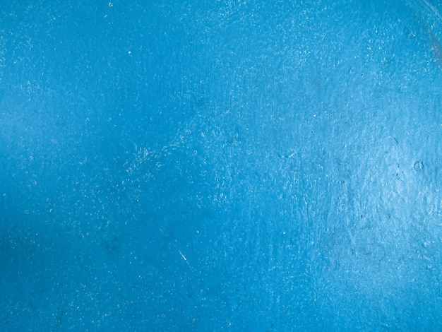 Close-up op de mat geschilderde blauwe achtergrond van de oppervlaktetextuur