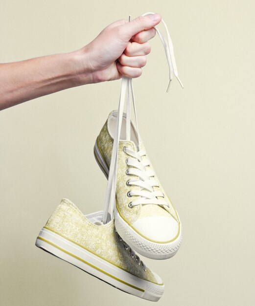 Close-up op hand met sneakers door schoenveters