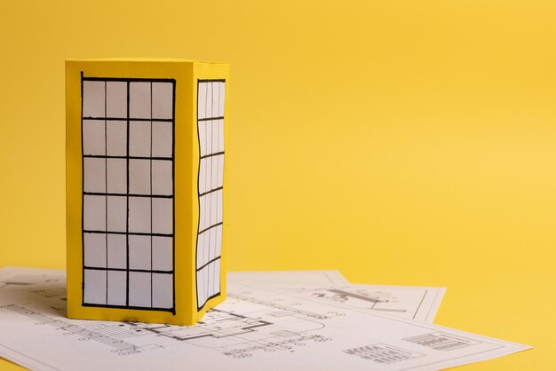 Close-up of open book on table against wall