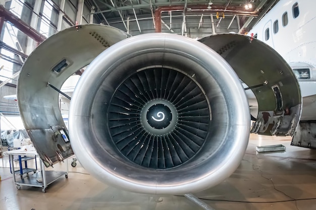 close up of open high bypass turbofan aircraft engine of a passenger airplane in an aviation hangar