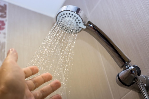Close up opened and closed water flowing from shower head in bathroom for take a shower concept