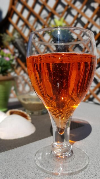 Close-up of orange aperitif in glass on table