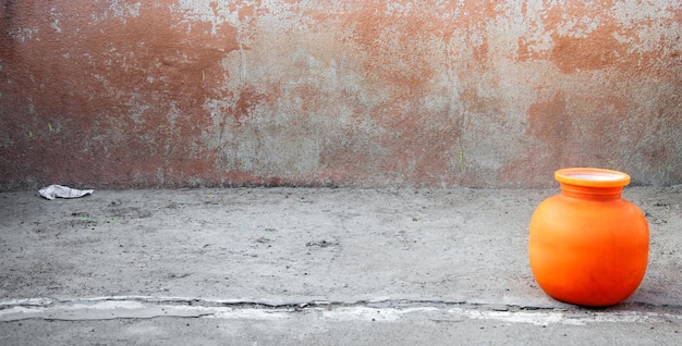 Close-up of orange bottle against wall