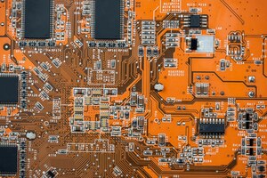 Photo close up of orange circuit board motherboard technology background computer component