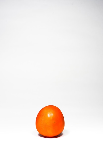 Photo close-up of orange fruit against white background