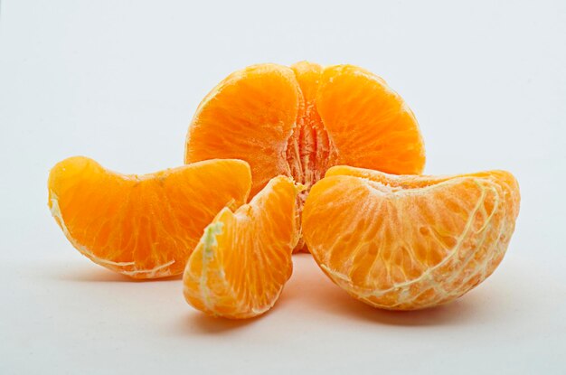 Close-up of orange fruit against white background